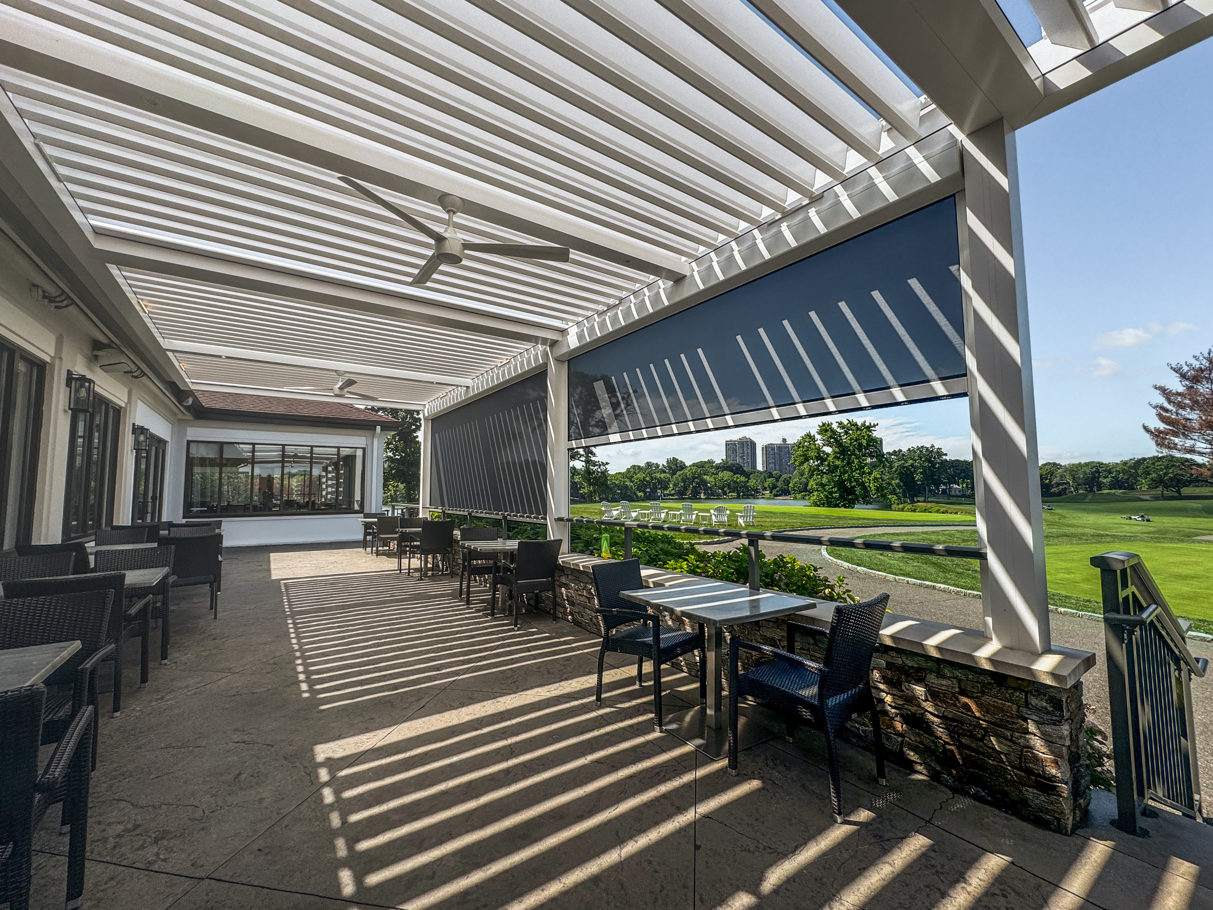 Interior view of the Lake Success Country Club pergola with louvers partially open