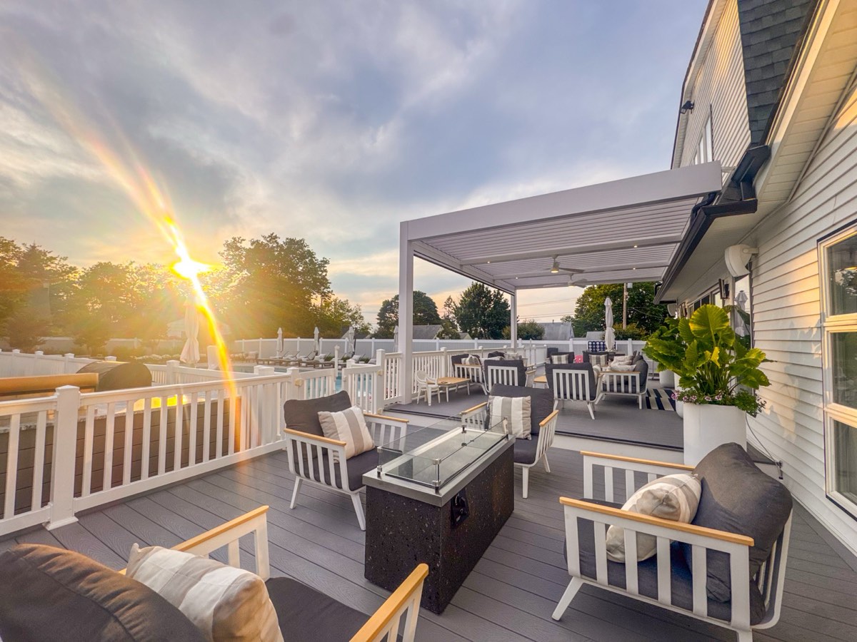 Modern poolside pergola with motorized retractable shade in Long Branch, NJ