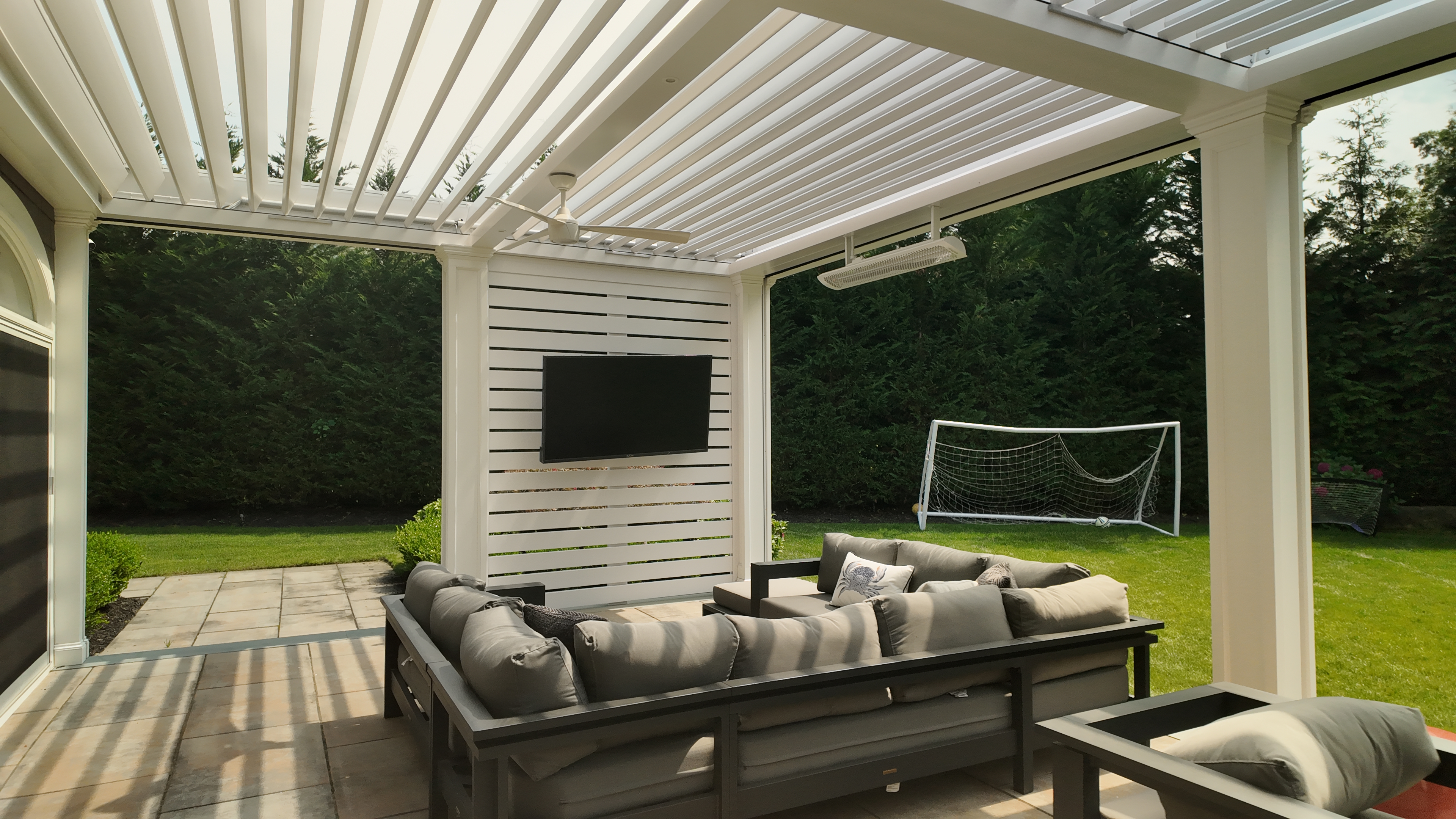 Custom Transitional Column Azenco Motorized Pergola with Concealed Motorized Screen shades, and Privacy wall with a TV mount, Manhasset NY