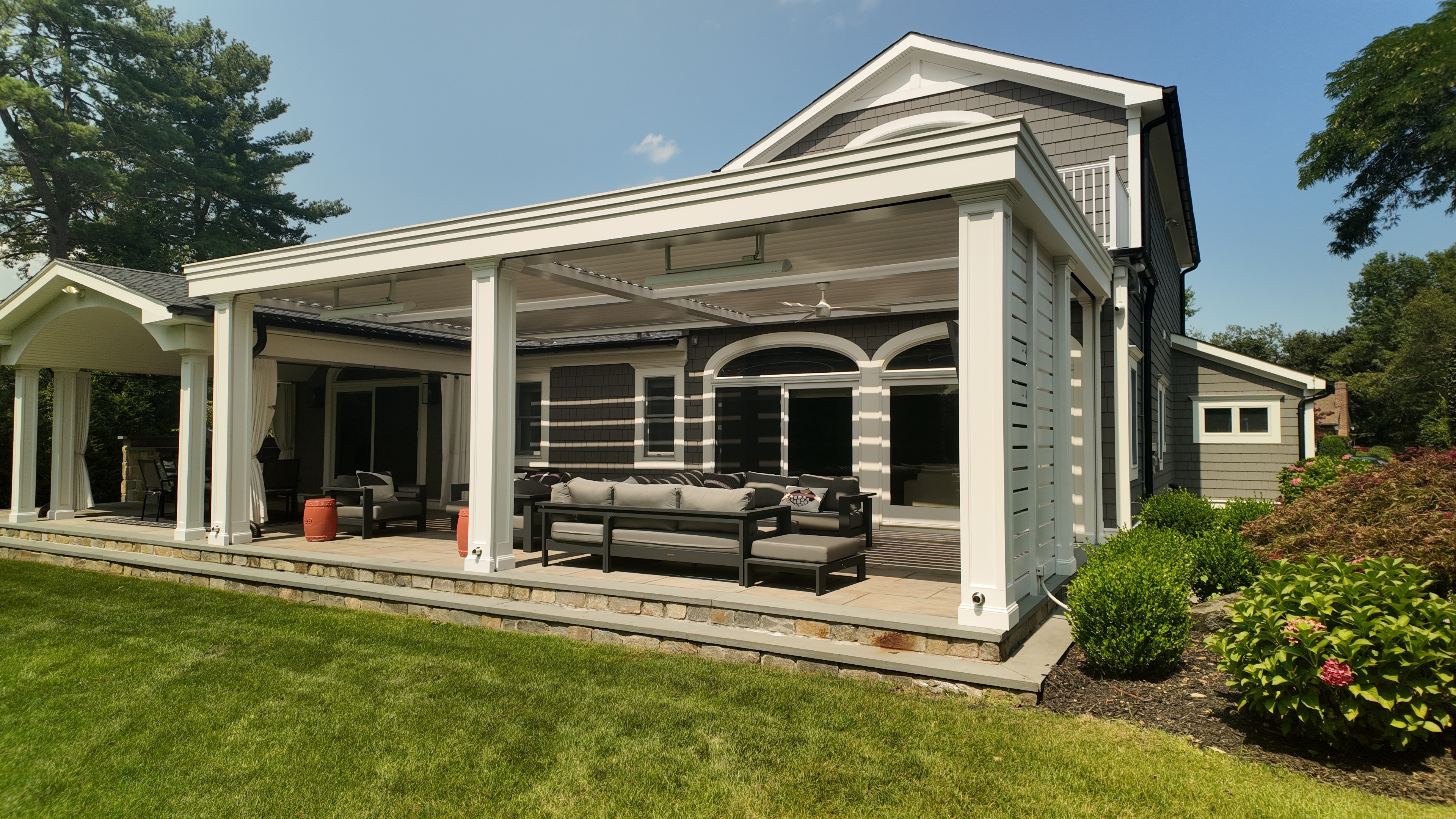 Custom Transitional Column Azenco Motorized Pergola with Concealed Motorized Screen shades, and Privacy wall with a TV mount, Manhasset NY