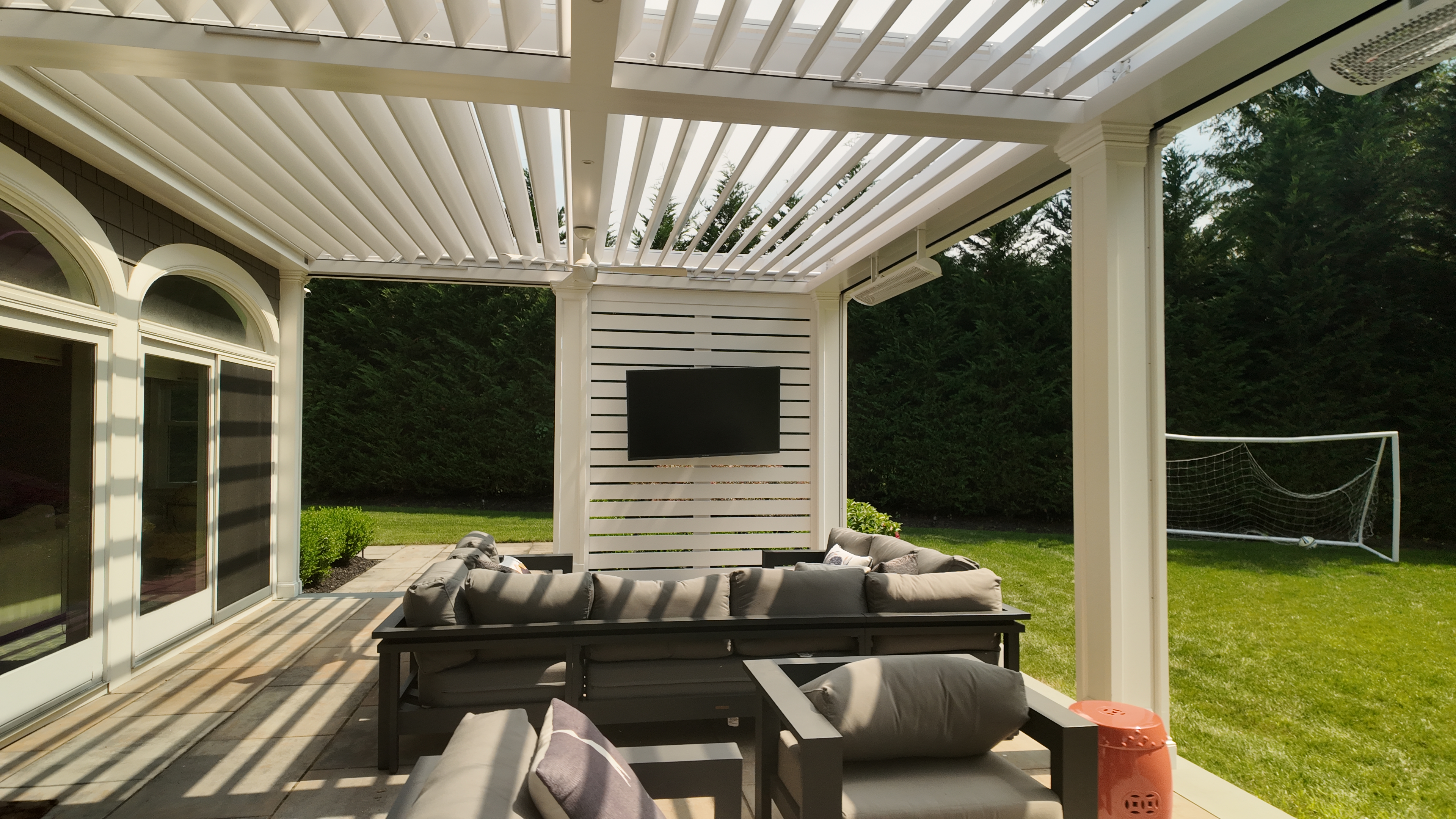 Custom Transitional Column Azenco Motorized Pergola with Concealed Motorized Screen shades, and Privacy wall with a TV mount, Manhasset NY