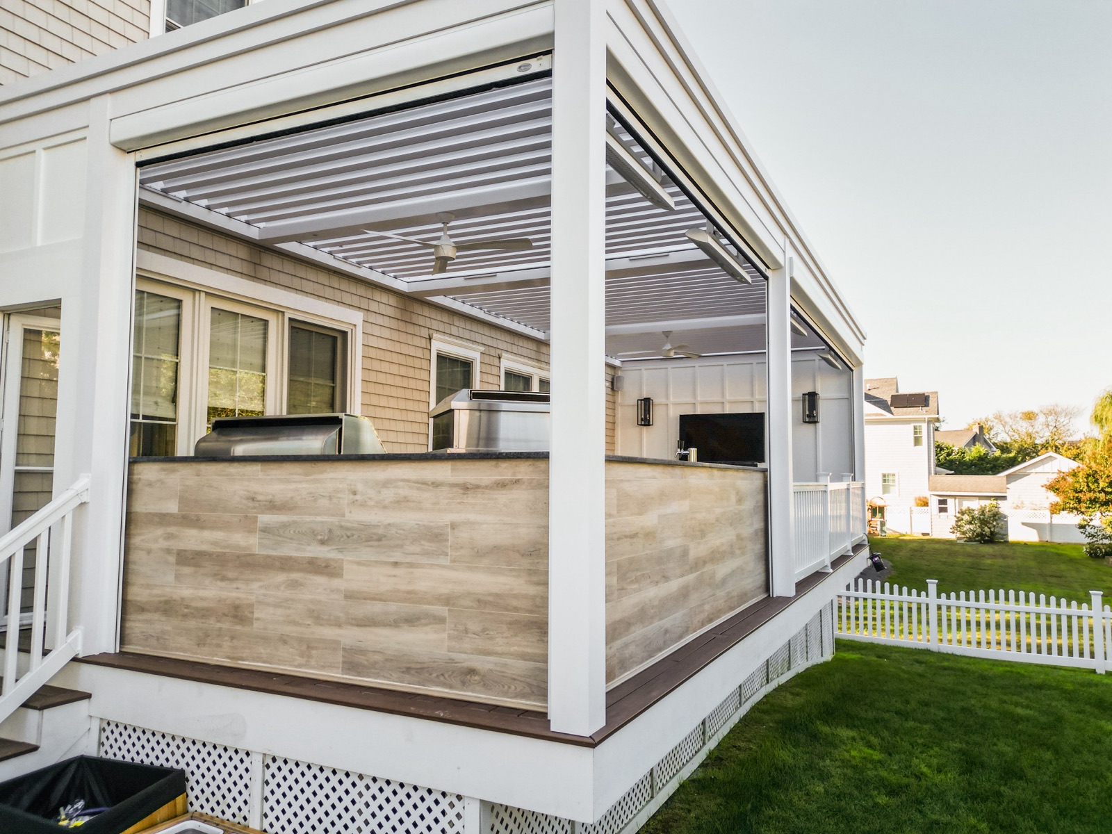 deck-mounted louvered roof + tv wall + outdoor kitchen pergola in Monmouth Beach, NJ