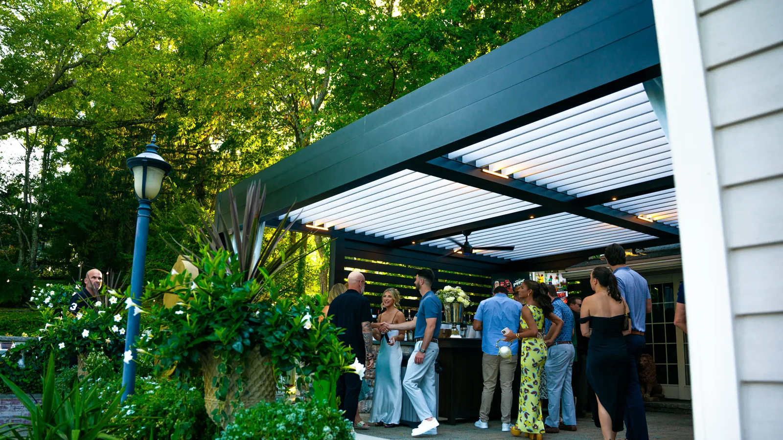 Wedding party under the Sansavero louvered-roof pergola