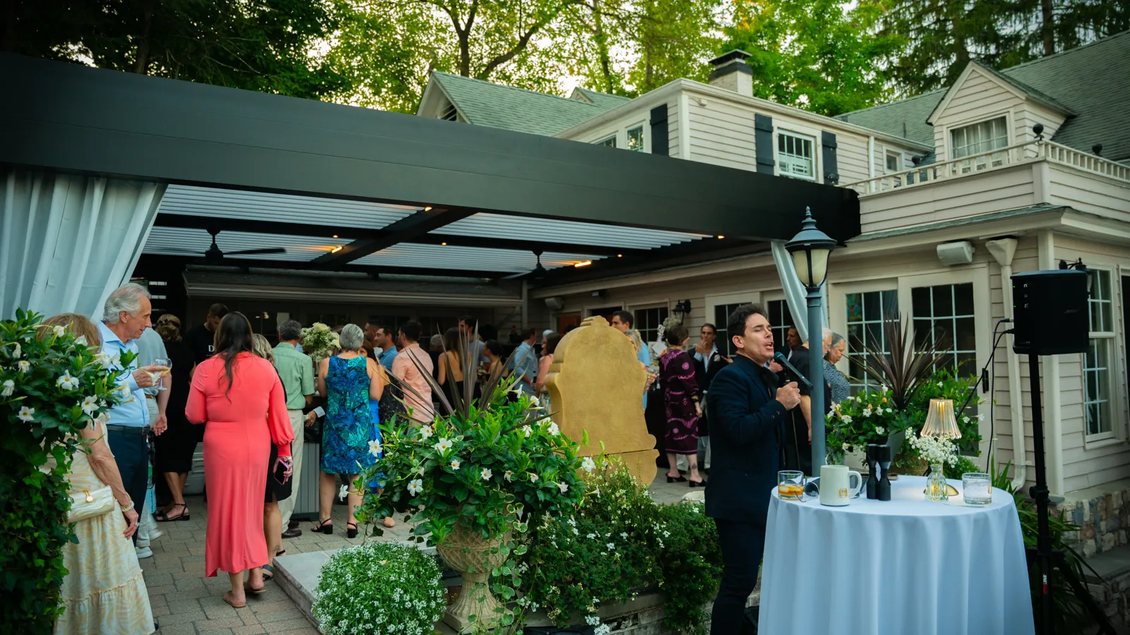 Sansavero pergola exterior at dusk — Azenco motorized louvered roof, East Hanover NJ