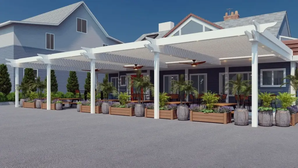 Row of white motorized pergola structures providing shade over a landscaped outdoor patio area beside a commercial building.
