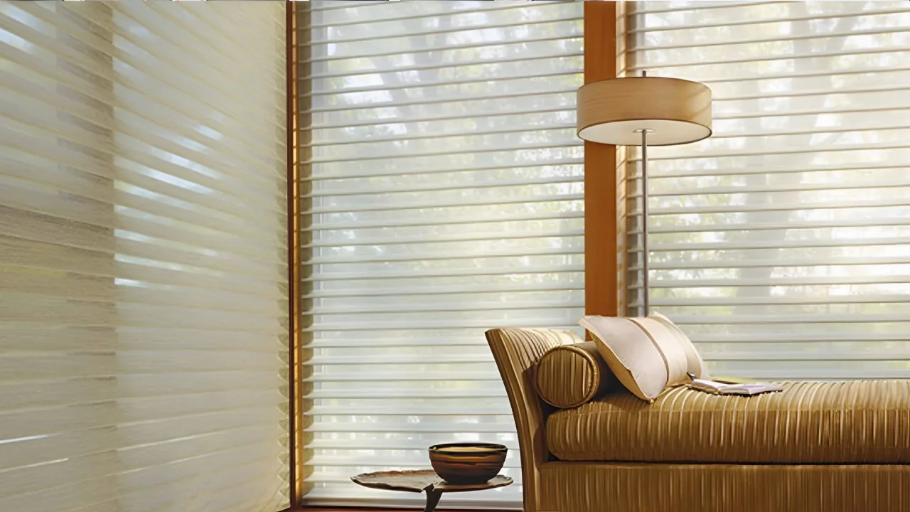 Sheer window shades filtering natural light in a cozy living space with a cushioned lounge chair, side table, and warm wooden accents.