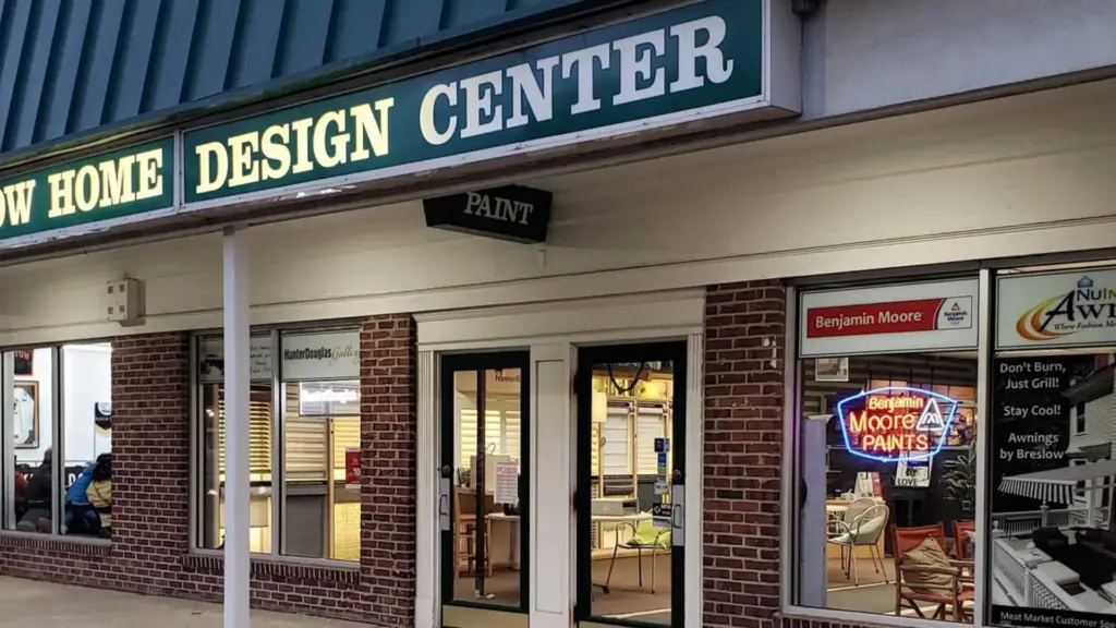 Exterior view of the Breslow Home Design Center storefront with illuminated windows and signage.
