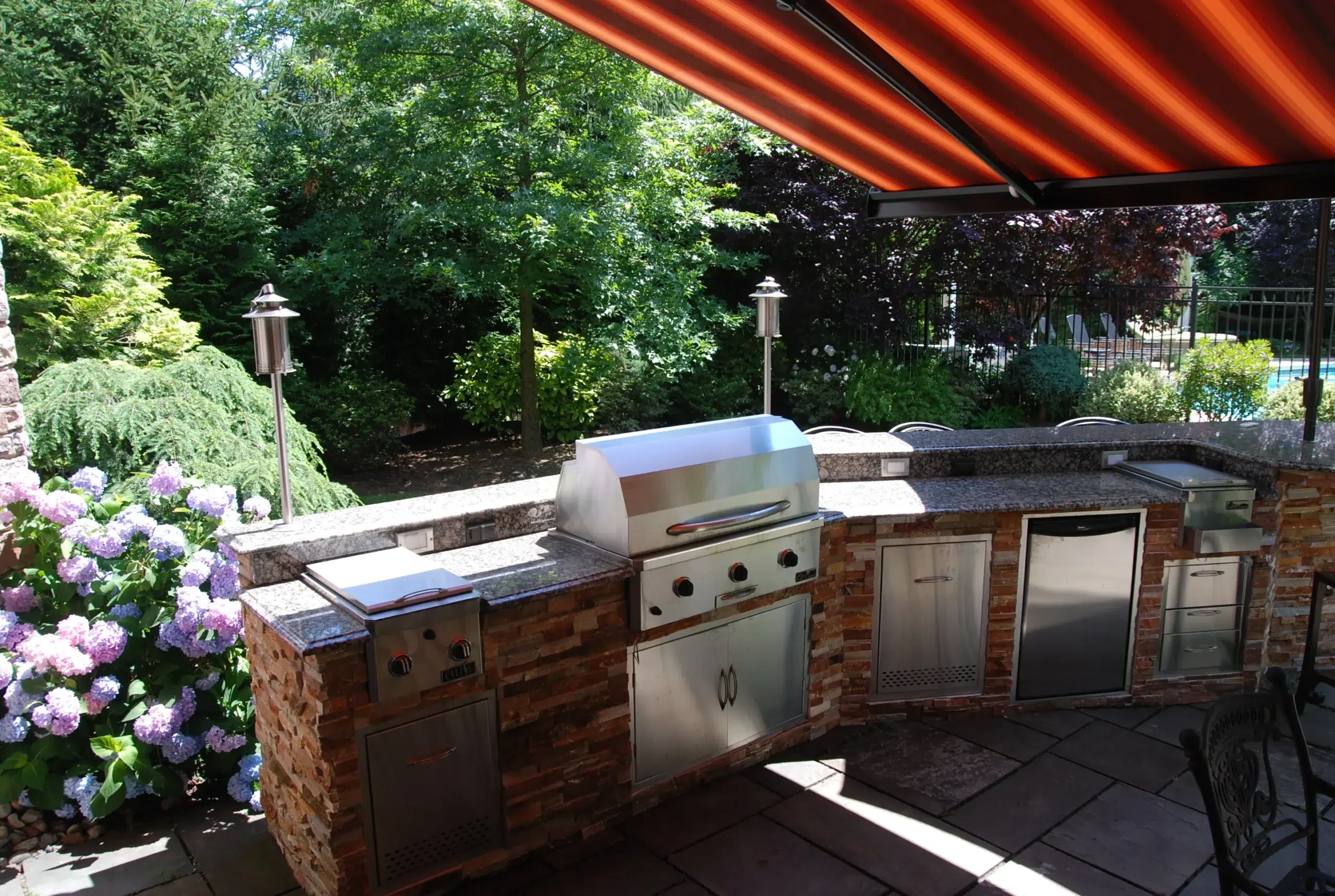 Patio with a retractable awning, complemented by cozy outdoor seating for relaxation and outdoor dining.