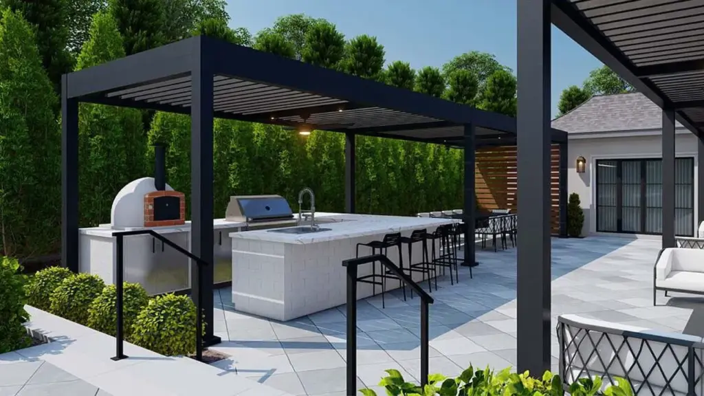 A sleek black modern pergola shading an outdoor kitchen with a pizza oven, grill, and bar-style seating in a landscaped backyard.